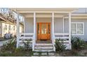 Inviting covered front porch, featuring a stylish wood door and stone accents at 1557 Alder Se Ct, Atlanta, GA 30317