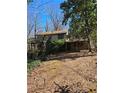 View of the backyard and elevated wood porch, showcasing the natural landscape at 3412 Sherrod Sw Dr, Marietta, GA 30060