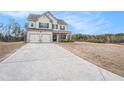 Home exterior featuring a large front lawn and a two-car garage at 18 Village Trce, Rydal, GA 30171