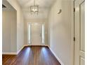 A welcoming foyer featuring gleaming hardwood floors and a stylish pendant light, creating an inviting entrance at 2506 Creek Station Dr, Buford, GA 30519
