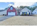 A well-maintained single-Gathering home features a mix of brick and siding, a two-car garage, and established landscaping at 2506 Creek Station Dr, Buford, GA 30519