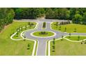 Aerial view of a meticulously designed neighborhood roundabout with manicured landscaping at 8588 Secretariat Dr, Lithonia, GA 30058