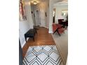 Inviting entryway with hardwood floors, modern rug, and a view of the dining area at 179 Silver Arrow Cir, Austell, GA 30168