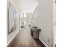 Inviting home hallway featuring wood flooring, neutral paint, natural lighting and decor at 5300 Willow Park Blvd, Atlanta, GA 30349