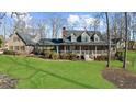 Scenic view of the property highlighting the spacious lawn and inviting facade of this beautiful home at 1511 Broadnax Mill Road, Loganville, GA 30052