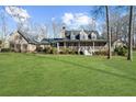 Beautiful home with a sprawling front lawn and inviting front porch, perfect for outdoor living at 1511 Broadnax Mill Road, Loganville, GA 30052