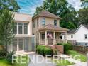 Two-story home with front porch, modern addition, and landscaped front yard at 301 Fortune St, Atlanta, GA 30312