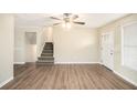 Open living area with staircase, wood-look floors, and a view of the front door and window at 3898 Rosedale Ln, Douglasville, GA 30135