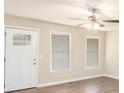 Bright living room featuring hardwood floors, ceiling fan, and a large window at 3898 Rosedale Ln, Douglasville, GA 30135