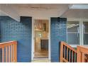 View from the front porch into the open-concept interior with hardwood floors and updated kitchen at 198 Scott St Nw, Atlanta, GA 30314