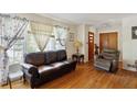 Cozy living room featuring gleaming hardwood floors, a large window, and a comfortable seating area at 1387 John Robert Dr, Morrow, GA 30260