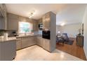 Well-lit kitchen features sleek countertops, tile flooring, and modern appliances with an open plan at 4149 Indian Lake Cir, Stone Mountain, GA 30083