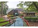 Community clubhouse with a green awning, a walkway and well-maintained landscaping at 783 Lost Creek Cir, Stone Mountain, GA 30088