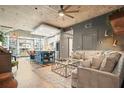 Open-concept living room with modern furnishings, a kitchen island and an exposed concrete ceiling at 890 Memorial Se Dr # 102, Atlanta, GA 30316