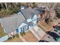 Aerial shot of a blue townhome with gray roof and stone landscaping at 836 Heritage Oaks Dr, Stone Mountain, GA 30088