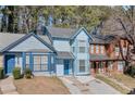 Charming blue two-story townhome featuring a bay window, adjacent to another unit at 836 Heritage Oaks Dr, Stone Mountain, GA 30088