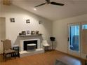 Inviting living room featuring a charming fireplace, ceiling fan, and access to the outdoors at 330 Warm Springs Cir, Roswell, GA 30075