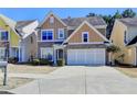 Inviting two-story home featuring a wide driveway and traditional architectural details at 2157 Staunton Dr, Duluth, GA 30096