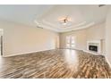 Spacious living room with hardwood floors, trey ceilings, fireplace, and French doors at 2985 Pilgrim Mill Rd, Cumming, GA 30041