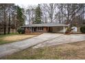 Attractive single-story home with large driveway and carport at 4292 Pinetree Dr, Powder Springs, GA 30127