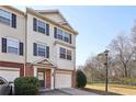 Inviting townhouse featuring a two-car garage and charming architectural details at 6798 Blackstone Pl # 12, Mableton, GA 30126