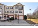 Inviting townhouse featuring a two-car garage and charming architectural details at 6798 Blackstone Pl # 12, Mableton, GA 30126