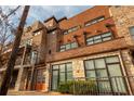 Multi-story brick building showing a mix of brick and stone with orange entry doors at 1199 Huff Nw Rd # 109, Atlanta, GA 30318
