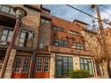 Multi-story brick building showing a mix of brick and stone with orange entry doors at 1199 Huff Nw Rd # 109, Atlanta, GA 30318
