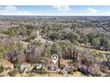 Scenic aerial view of the property nestled amongst trees in a neighborhood with nearby roads and foliage at 122 Dials Dr, Woodstock, GA 30188