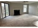 A bright living room with a sliding glass door to the outside and a cozy fireplace at 1376 Keys Lake Ne Dr, Brookhaven, GA 30319