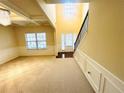 Inviting foyer with soaring ceilings, elegant wainscoting, and a staircase leading to the upper level at 3309 Gardenside Walk, Loganville, GA 30052