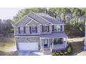 Aerial view of a charming two-story brick home featuring a covered porch and an attached two-car garage at 3309 Gardenside Walk, Loganville, GA 30052