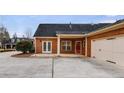 Rear exterior showing brick siding, double doors, and a two car garage at 1404 Haven Cir, Douglasville, GA 30135