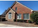 Attractive single-story home featuring brick and stone accents, complemented by manicured greenery at 1404 Haven Cir, Douglasville, GA 30135