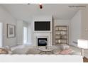 Digitally staged living room with a fireplace and decorative shelving at 1404 Haven Cir, Douglasville, GA 30135