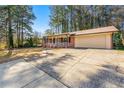 This house features a brick facade, attached garage and a classic front porch at 1465 Rockbridge Rd, Stone Mountain, GA 30087