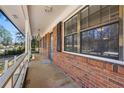 Close-up of the front porch, showcasing brick detail and large windows at 1465 Rockbridge Rd, Stone Mountain, GA 30087