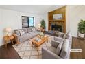 Cozy living room featuring a stone fireplace, large window and comfortable seating at 2658 Kellogg Creek Rd, Acworth, GA 30102