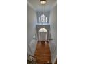 Grand foyer with high ceilings, wood floors, and a modern chandelier, offering a bright and welcoming entrance at 3302 Fieldwood Se Dr, Smyrna, GA 30080