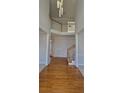 Bright foyer with hardwood floors, high ceilings, and a staircase with white railings and wood accents at 3302 Fieldwood Se Dr, Smyrna, GA 30080
