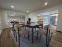 Well-lit dining room with hardwood floors and an open view into the living room at 3576 Pinehill Cir, Acworth, GA 30101