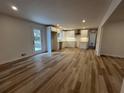 Bright, open kitchen featuring white cabinets, stainless steel appliances, and modern wood-look flooring at 3576 Pinehill Cir, Acworth, GA 30101