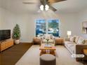 Bright living room with large window, modern furniture, and hardwood floors at 1376 Cornwall Rd, Decatur, GA 30032