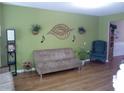 Living room with modern decor, a large window, and hardwood floors at 1975 Lily Stem Trl, Auburn, GA 30011