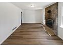 Bright living room featuring a brick fireplace and wood flooring at 2622 Abington Dr, Snellville, GA 30078