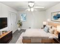 Staged main bedroom featuring a ceiling fan, large window, and natural light at 2622 Abington Dr, Snellville, GA 30078