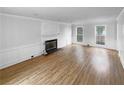 Bright living room featuring a fireplace, white trim and hardwood floors at 1302 Milstead Ne Trce, Marietta, GA 30066