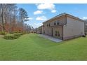 Spacious backyard featuring lush green grass and a concrete patio at 1777 Holman Forest Ct, Hoschton, GA 30548