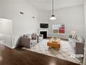 Bright living room with vaulted ceilings, fireplace, and large window allowing lots of natural light at 213 Ermines Way, Mcdonough, GA 30253