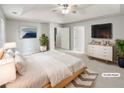 Serene main bedroom with tray ceiling, walk-in closet, and calm decor, virtually staged at 2545 Lakemeadow Ln, Grayson, GA 30017